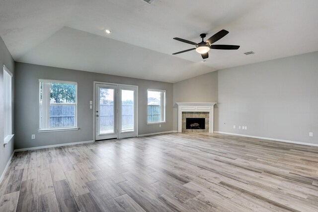 431 Cardinal Oaks, League City, TX 77565 - unfurnished living room featuring lofted ceiling, wood finished floors, ceiling fan, baseboards, and a tile fireplace