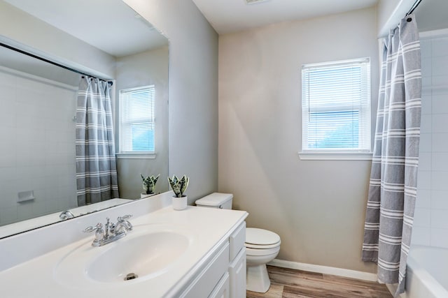 431 Cardinal Oaks, League City, TX 77565 - bathroom featuring wood finished floors, vanity, toilet, shower / bathtub combination with curtain, and baseboards