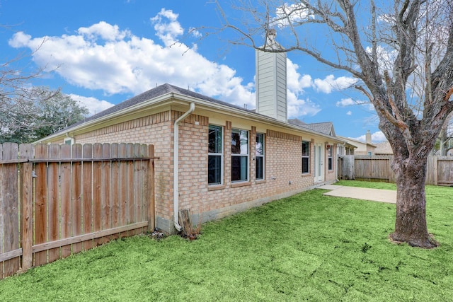 431 Cardinal Oaks, League City, TX 77565 - rear view of property featuring brick siding, a chimney, a patio, and a shingled roof