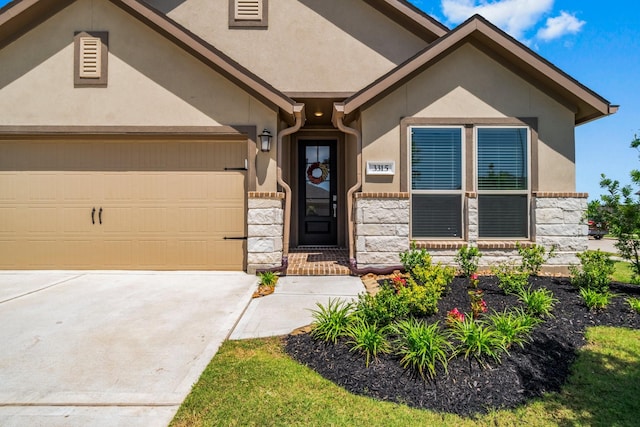 3315 Bristle Ridge Ln, Brookshire, TX 77423 - view of front of property featuring stone siding, an attached garage, and stucco siding