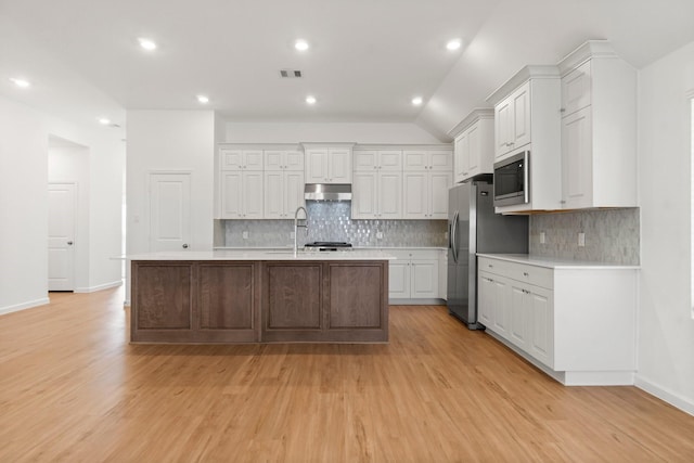 3315 Bristle Ridge Ln, Brookshire, TX 77423 - kitchen with light countertops, white cabinets, light wood finished floors, under cabinet range hood, and recessed lighting