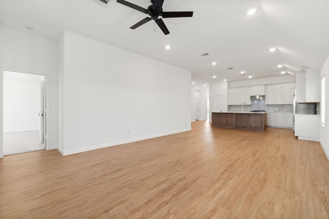 3315 Bristle Ridge Ln, Brookshire, TX 77423 - unfurnished living room with a sink, recessed lighting, a ceiling fan, light wood-style flooring, and baseboards