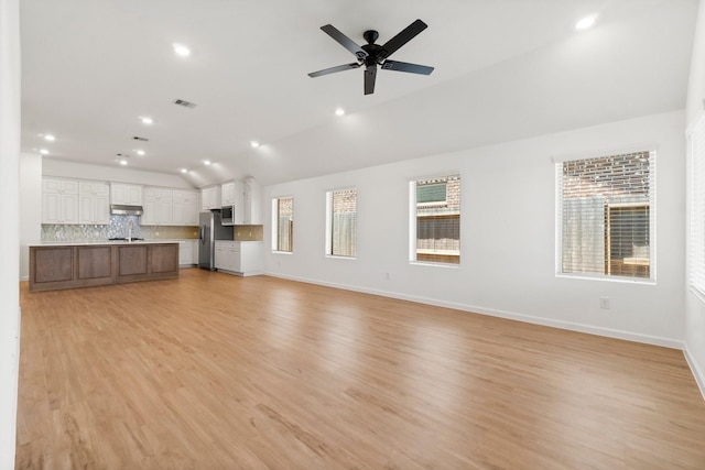 3315 Bristle Ridge Ln, Brookshire, TX 77423 - unfurnished living room featuring vaulted ceiling, light wood-style floors, baseboards, a ceiling fan, and recessed lighting