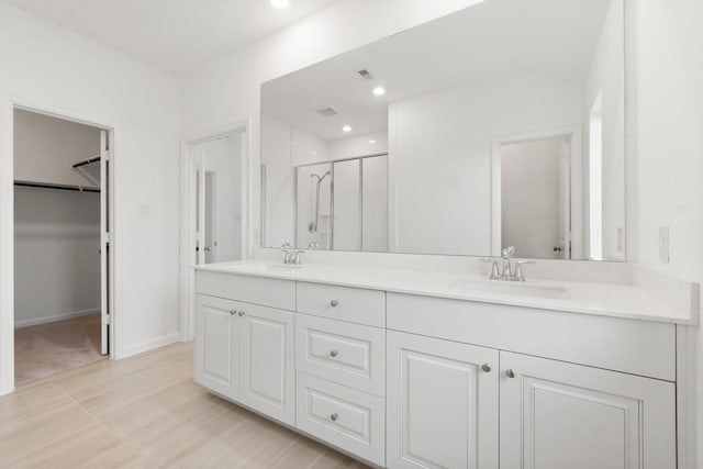 3315 Bristle Ridge Ln, Brookshire, TX 77423 - bathroom with a shower stall, double vanity, a walk in closet, and recessed lighting