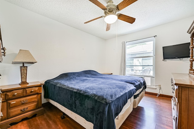 16358 Havenpark Dr, Houston, TX 77059 - bedroom featuring dark wood finished floors, baseboards, a textured ceiling, and ceiling fan