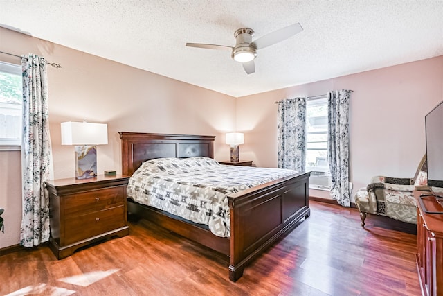 16358 Havenpark Dr, Houston, TX 77059 - bedroom with dark wood finished floors, multiple windows, a textured ceiling, and ceiling fan