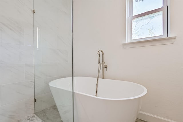 16358 Havenpark Dr, Houston, TX 77059 - full bathroom with baseboards and a freestanding tub