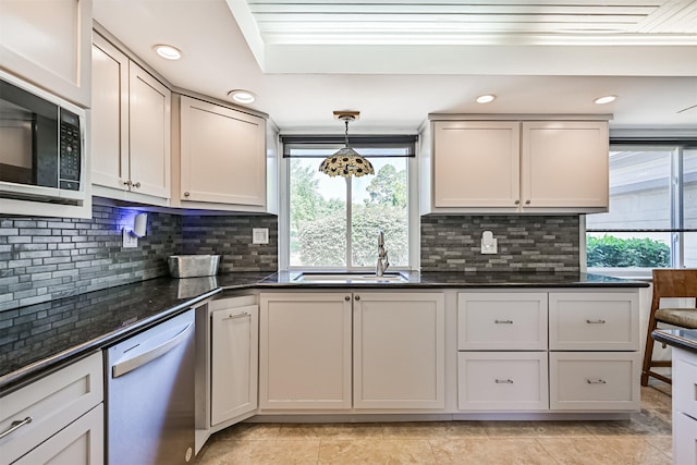 16358 Havenpark Dr, Houston, TX 77059 - kitchen featuring dishwashing machine, a sink, stainless steel microwave, tasteful backsplash, and decorative light fixtures