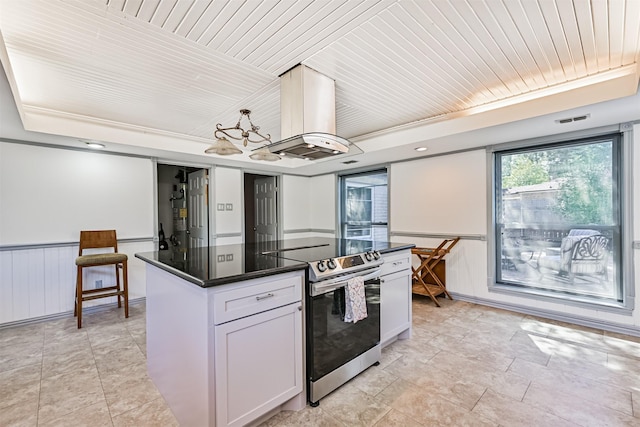 16358 Havenpark Dr, Houston, TX 77059 - kitchen with stainless steel range with electric cooktop, island range hood, a chandelier, a kitchen island, and white cabinets