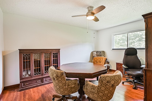 16358 Havenpark Dr, Houston, TX 77059 - dining area featuring an office area, wood finished floors, a textured ceiling, ceiling fan, and baseboards