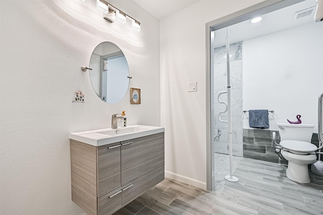 16358 Havenpark Dr, Houston, TX 77059 - bathroom featuring vanity, toilet, wood finished floors, baseboards, and a shower