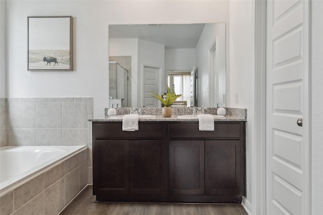 18414 Christine Elizabeth Ln, New Caney, TX 77357 - full bath with a shower stall, a bath, wood finished floors, and double vanity