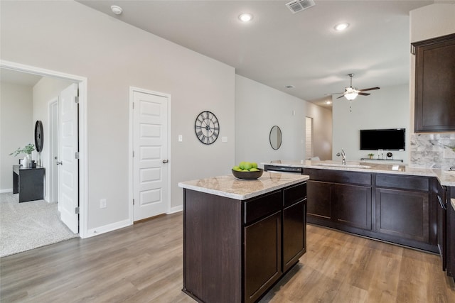 18414 Christine Elizabeth Ln, New Caney, TX 77357 - kitchen with a sink, dark brown cabinets, ceiling fan, light wood finished floors, and recessed lighting