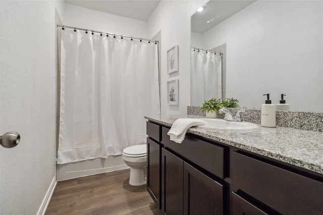 18414 Christine Elizabeth Ln, New Caney, TX 77357 - bathroom featuring wood finished floors, toilet, vanity, baseboards, and shower / bath combo with shower curtain