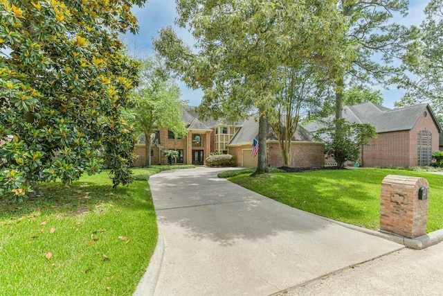 8410 Atascocita Lake Way, Humble, TX 77346 - view of front facade featuring brick siding, a front lawn, driveway, and a shingled roof