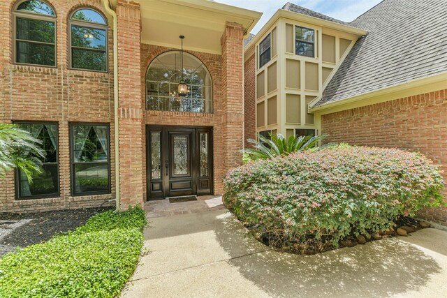 8410 Atascocita Lake Way, Humble, TX 77346 - property entrance featuring brick siding and roof with shingles
