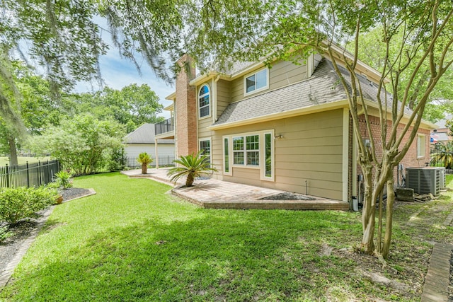 8410 Atascocita Lake Way, Humble, TX 77346 - rear view of property featuring central air condition unit, a chimney, a patio area, and a shingled roof
