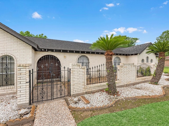 11821 15th St, Santa Fe, TX 77510 - view of front of house with brick siding, a gate, a fenced front yard, and a shingled roof