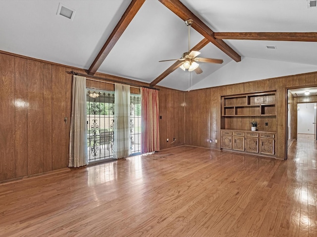 11821 15th St, Santa Fe, TX 77510 - unfurnished living room with wood walls, ceiling fan, wood finished floors, and built in features