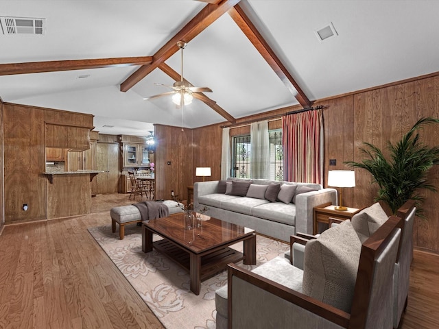 11821 15th St, Santa Fe, TX 77510 - living room with light wood finished floors, wooden walls, and ceiling fan