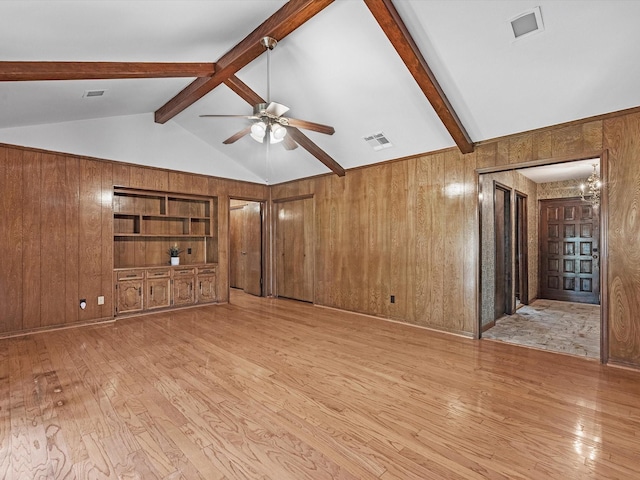 11821 15th St, Santa Fe, TX 77510 - unfurnished living room with a ceiling fan, light wood-style floors, and wooden walls