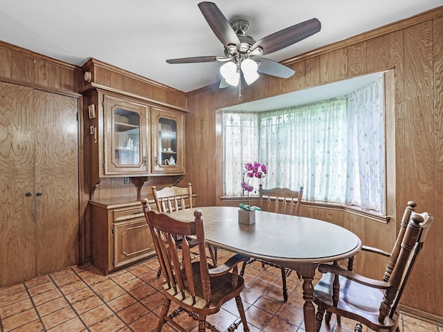 11821 15th St, Santa Fe, TX 77510 - dining space featuring wood walls, a ceiling fan, and light tile patterned flooring