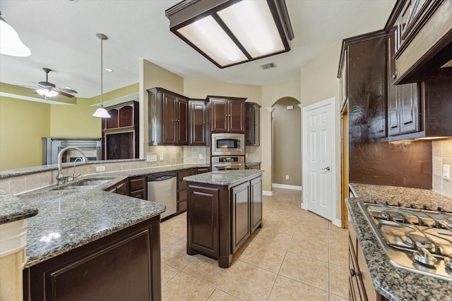 10707 Mandavilla Dr, Houston, TX 77095 - kitchen with appliances with stainless steel finishes, a sink, backsplash, arched walkways, and a ceiling fan