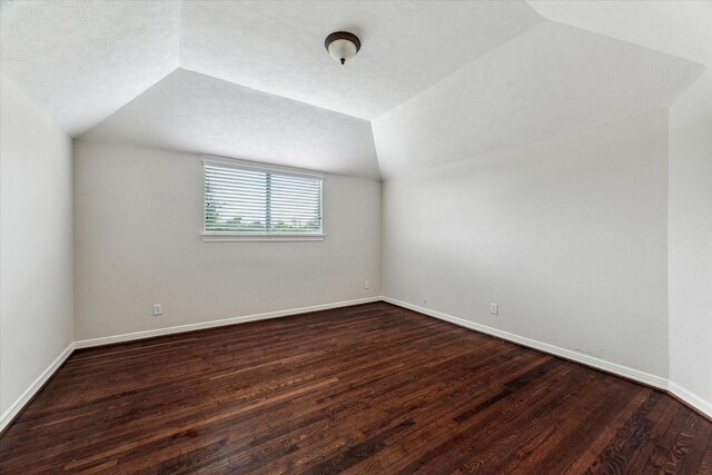 10707 Mandavilla Dr, Houston, TX 77095 - bonus room featuring dark wood finished floors, lofted ceiling, and baseboards