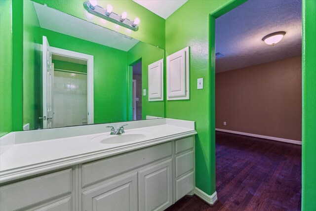 10707 Mandavilla Dr, Houston, TX 77095 - bathroom featuring vanity, wood finished floors, baseboards, and a shower