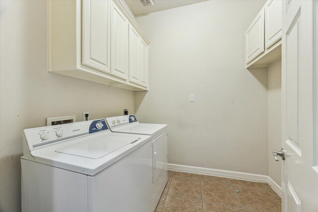 10707 Mandavilla Dr, Houston, TX 77095 - washroom featuring cabinet space, washer and dryer, baseboards, and light tile patterned floors