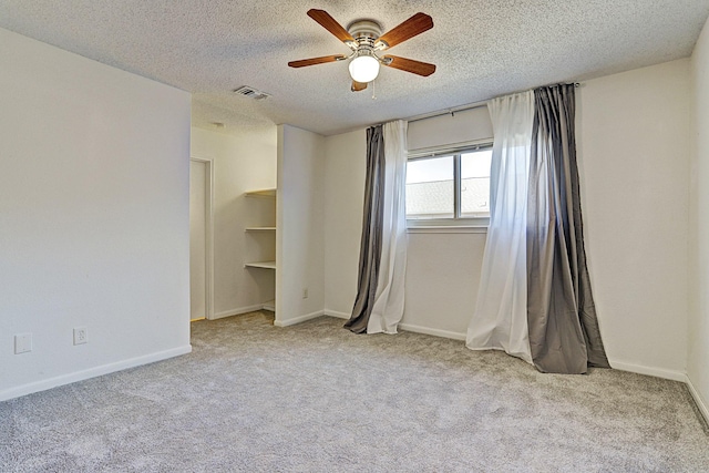13948 Hollowgreen Dr Unit 25, Houston, TX 77082 - carpeted spare room with ceiling fan, a textured ceiling, and baseboards