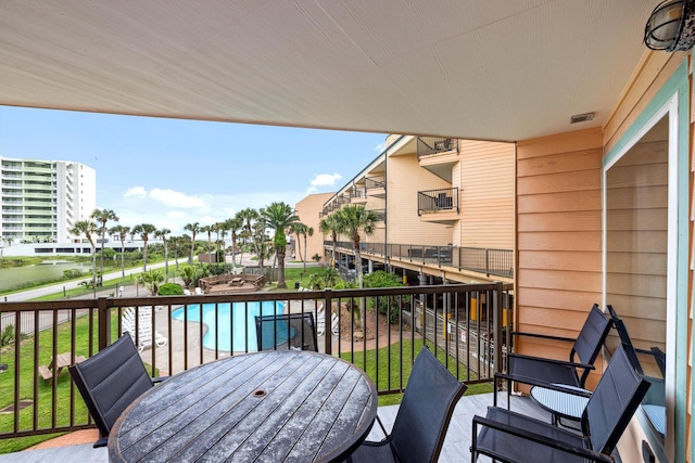 9520 Seawall Blvd Unit 152, Galveston, TX 77554 - balcony featuring view of pool area and outdoor dining area