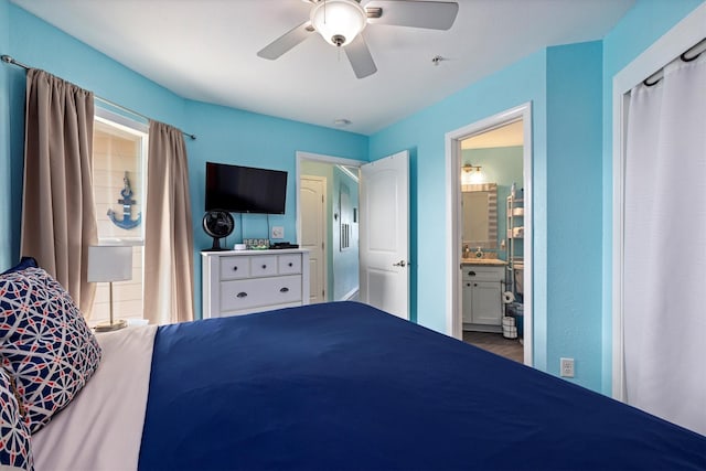 9520 Seawall Blvd Unit 152, Galveston, TX 77554 - bedroom with a ceiling fan, connected bathroom, and wood finished floors