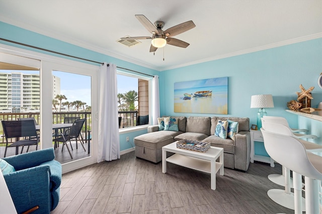 9520 Seawall Blvd Unit 152, Galveston, TX 77554 - living room featuring ornamental molding, wood finished floors, a ceiling fan, and baseboards