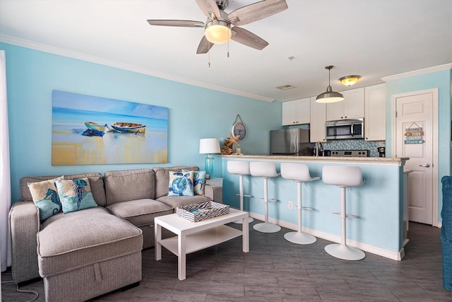 9520 Seawall Blvd Unit 152, Galveston, TX 77554 - living room with crown molding, dark wood-style flooring, a ceiling fan, and baseboards
