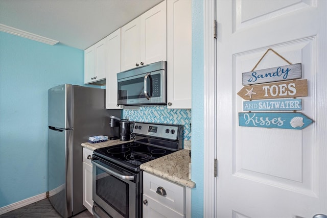 9520 Seawall Blvd Unit 152, Galveston, TX 77554 - kitchen with stainless steel appliances, white cabinets, decorative backsplash, and baseboards