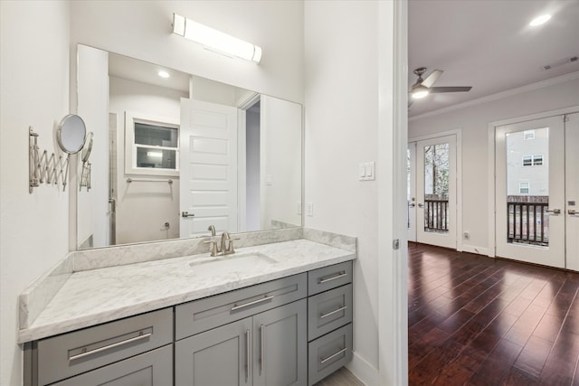 1032 W 18th St, Houston, TX 77008 - bathroom with crown molding, wood finished floors, a ceiling fan, baseboards, and vanity