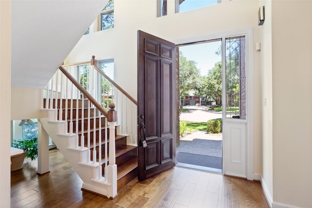 22015 Fielder Dr, Katy, TX 77450 - foyer featuring hardwood / wood-style flooring, a towering ceiling, stairs, and baseboards