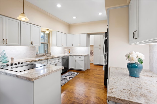 22015 Fielder Dr, Katy, TX 77450 - kitchen with black appliances, a sink, backsplash, hanging light fixtures, and light wood finished floors