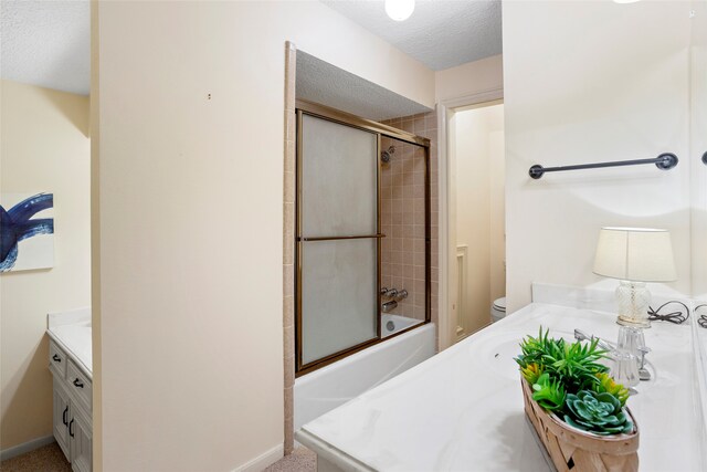 22015 Fielder Dr, Katy, TX 77450 - full bathroom featuring vanity, a textured ceiling, toilet, bath / shower combo with glass door, and baseboards
