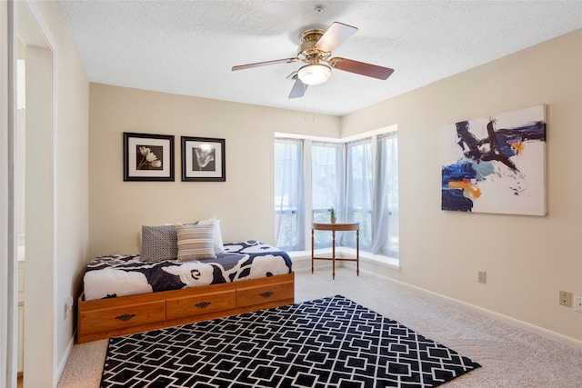 22015 Fielder Dr, Katy, TX 77450 - living area featuring carpet, a textured ceiling, baseboards, and a ceiling fan