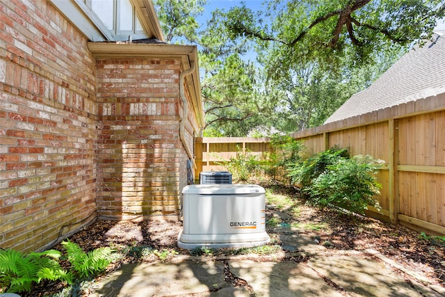 22015 Fielder Dr, Katy, TX 77450 - exterior view of brick siding, a fenced backyard, a power unit, and central AC