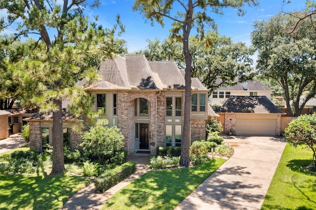 22015 Fielder Dr, Katy, TX 77450 - view of front facade with a garage, brick siding, driveway, and a front lawn