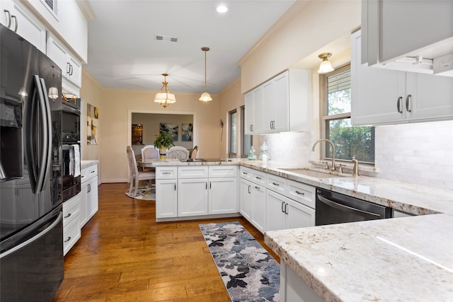 22015 Fielder Dr, Katy, TX 77450 - kitchen with stainless steel appliances, a sink, a peninsula, tasteful backsplash, and hardwood / wood-style flooring