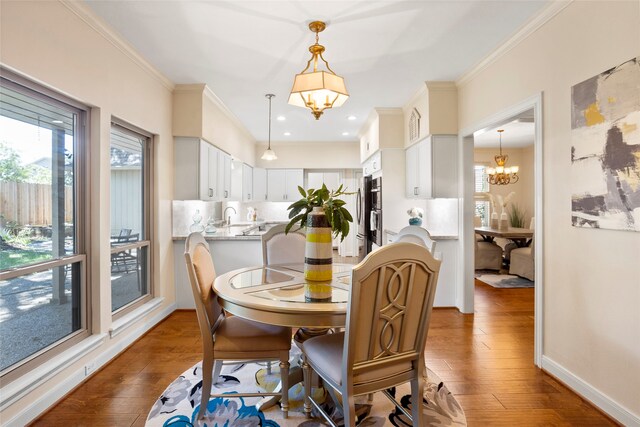 22015 Fielder Dr, Katy, TX 77450 - dining space featuring a chandelier, plenty of natural light, wood-type flooring, and crown molding