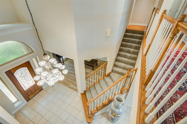 218 Moss Rose Ln, Lake Jackson, TX 77566 - tiled foyer with stairway, a towering ceiling, and a chandelier