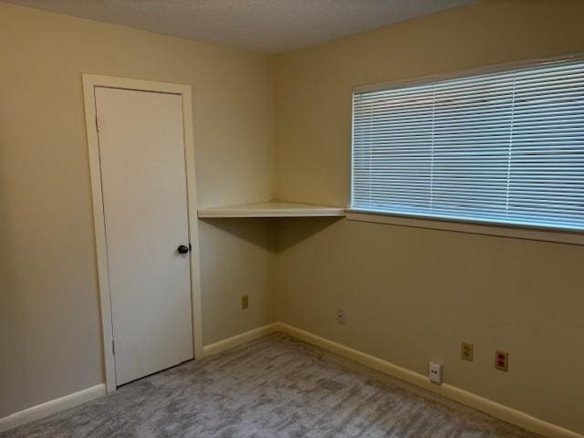 5542 Holly St Unit 206, Houston, TX 77081 - empty room with carpet flooring, baseboards, and a textured ceiling