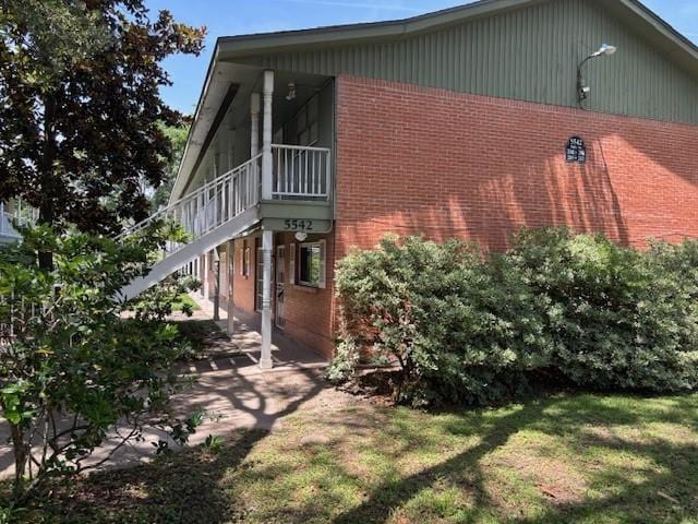 5542 Holly St Unit 206, Houston, TX 77081 - view of side of property with brick siding and a yard