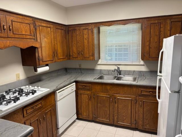 5542 Holly St Unit 206, Houston, TX 77081 - kitchen featuring white appliances, a sink, and light tile patterned floors
