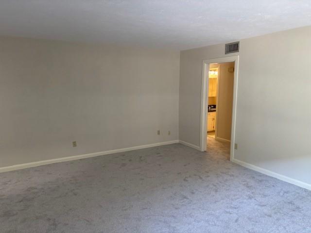5542 Holly St Unit 206, Houston, TX 77081 - carpeted spare room with baseboards